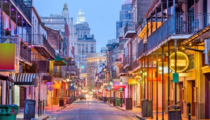 Bourbon St, New Orleans, Louisiana, USA cityscape of bars and restaurants at twilight