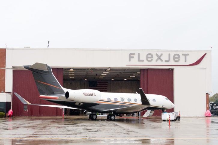 flexjet plane outside airport hangar