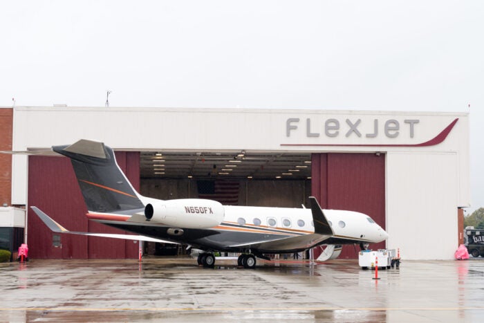 flexjet plane outside airport hangar