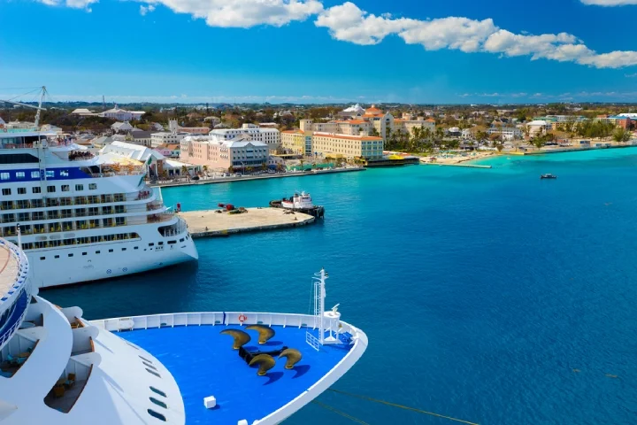 A view of a large cruise ship docked along the waterfront of Nassau, Bahamas.