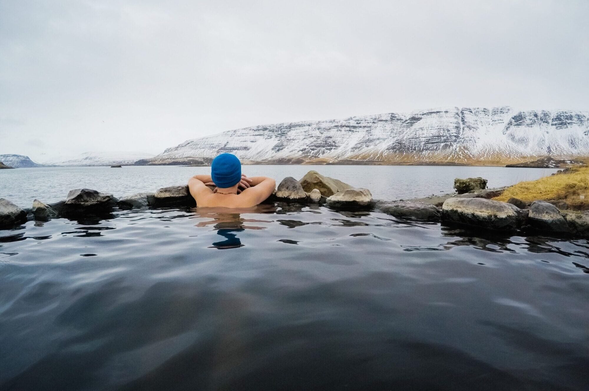 Swimmer looking out at Icelandic mountains