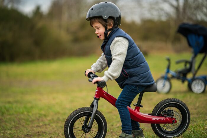 Child riding the bentley balance bike outside 