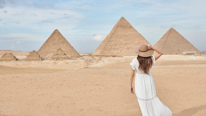 woman in front of pyramids in egypt