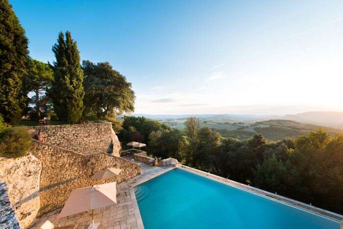 The infinity pool at Borgo Pignano overlooking the hills