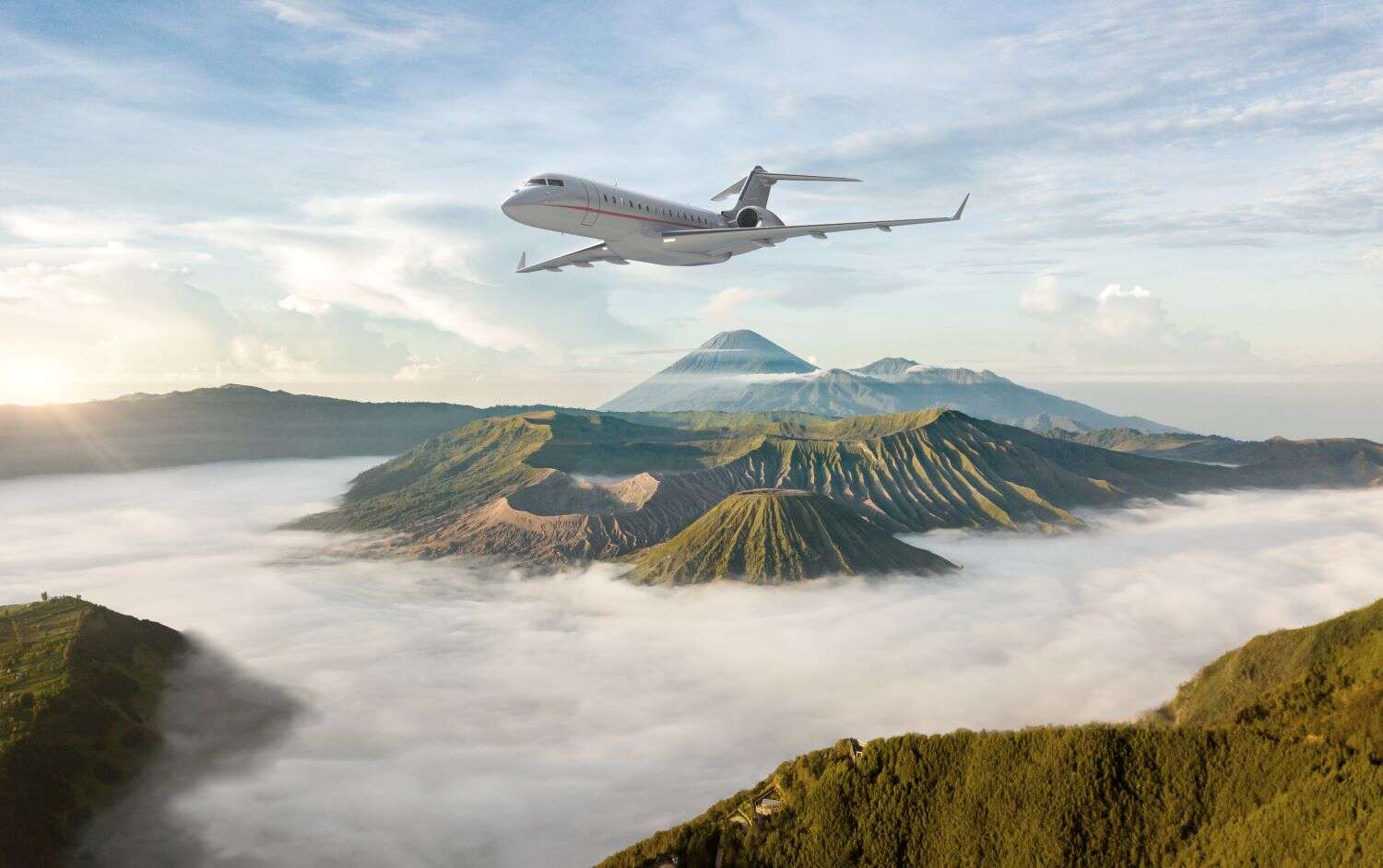 VistaJet plane flying over mount