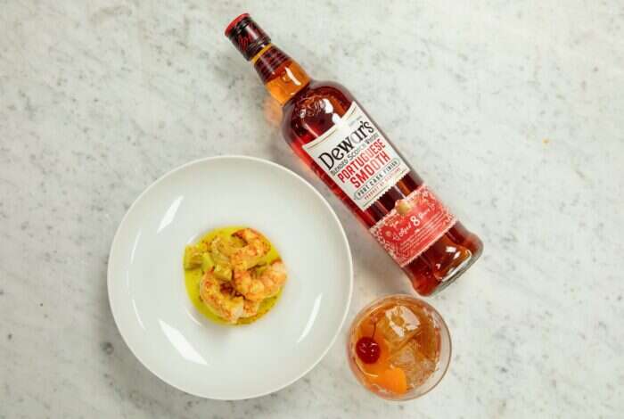 dewar's portugese smooth on table next to chef mendes shrimp dish