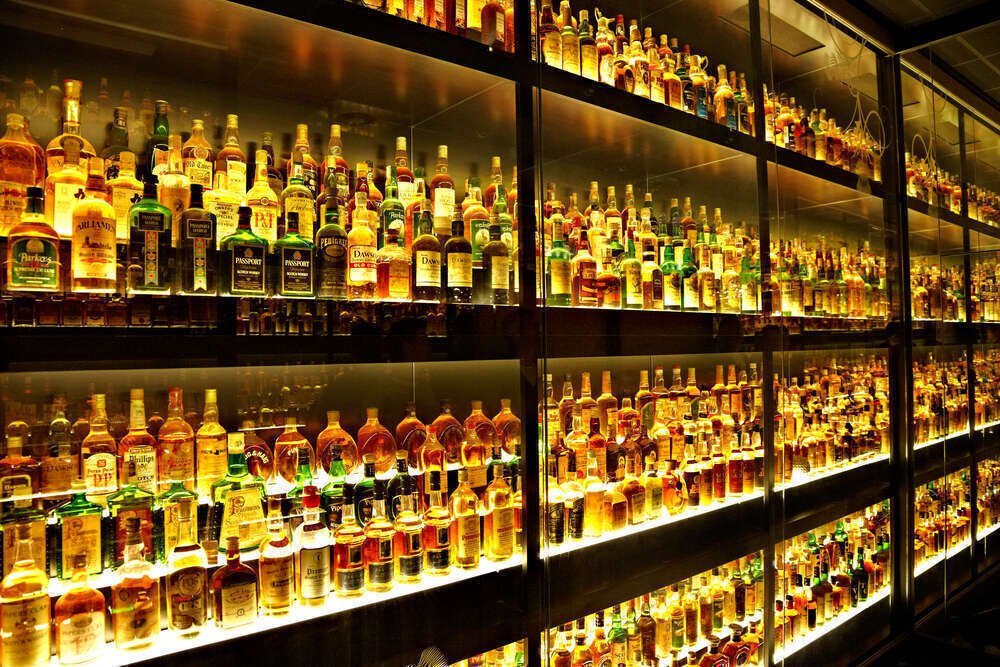 Collection of 100's of Scotch bottles in Cabinet