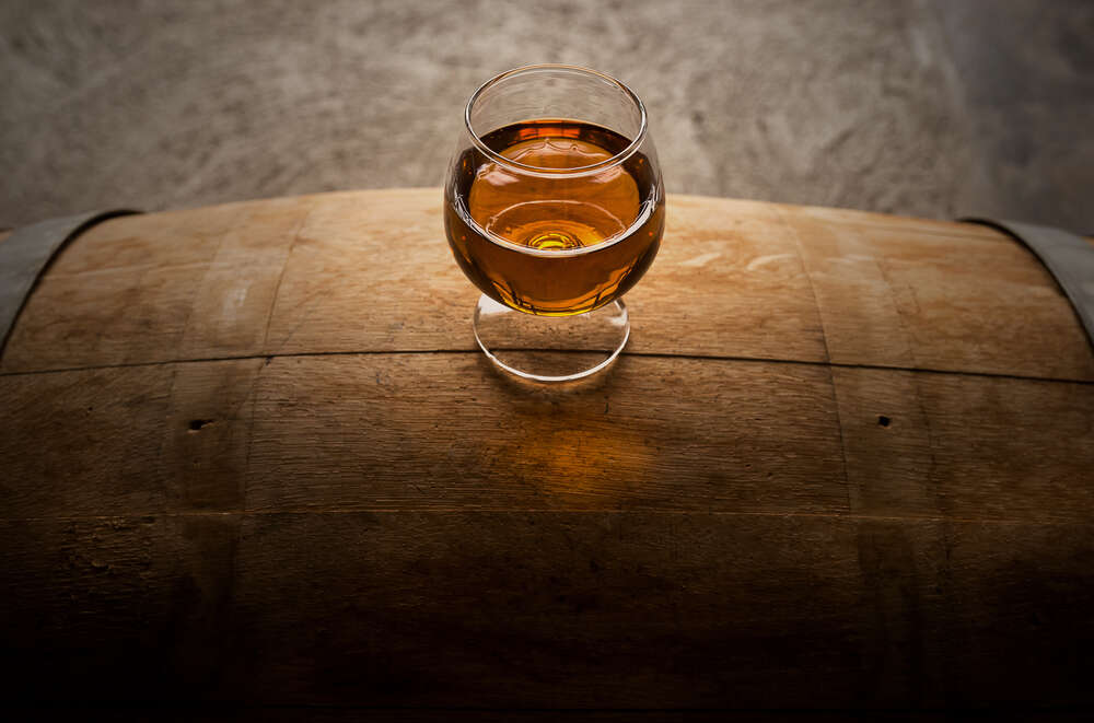 Dram of whisky atop a barrel
