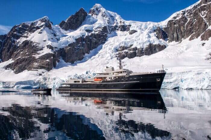 Exterior of Legend yacht with snow covered mountains 