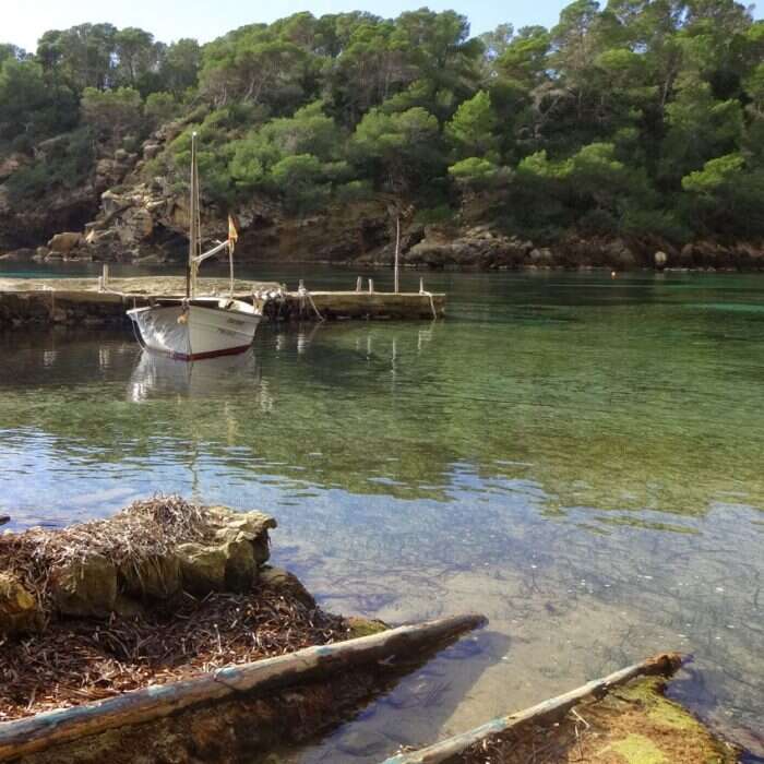 secluded bay with boat in ibiza