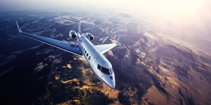 Private jet flying over mountains