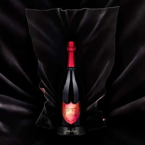 Lady Gaga and enfolds a jeroboam of Dom Pérignon Sculpture - Behind