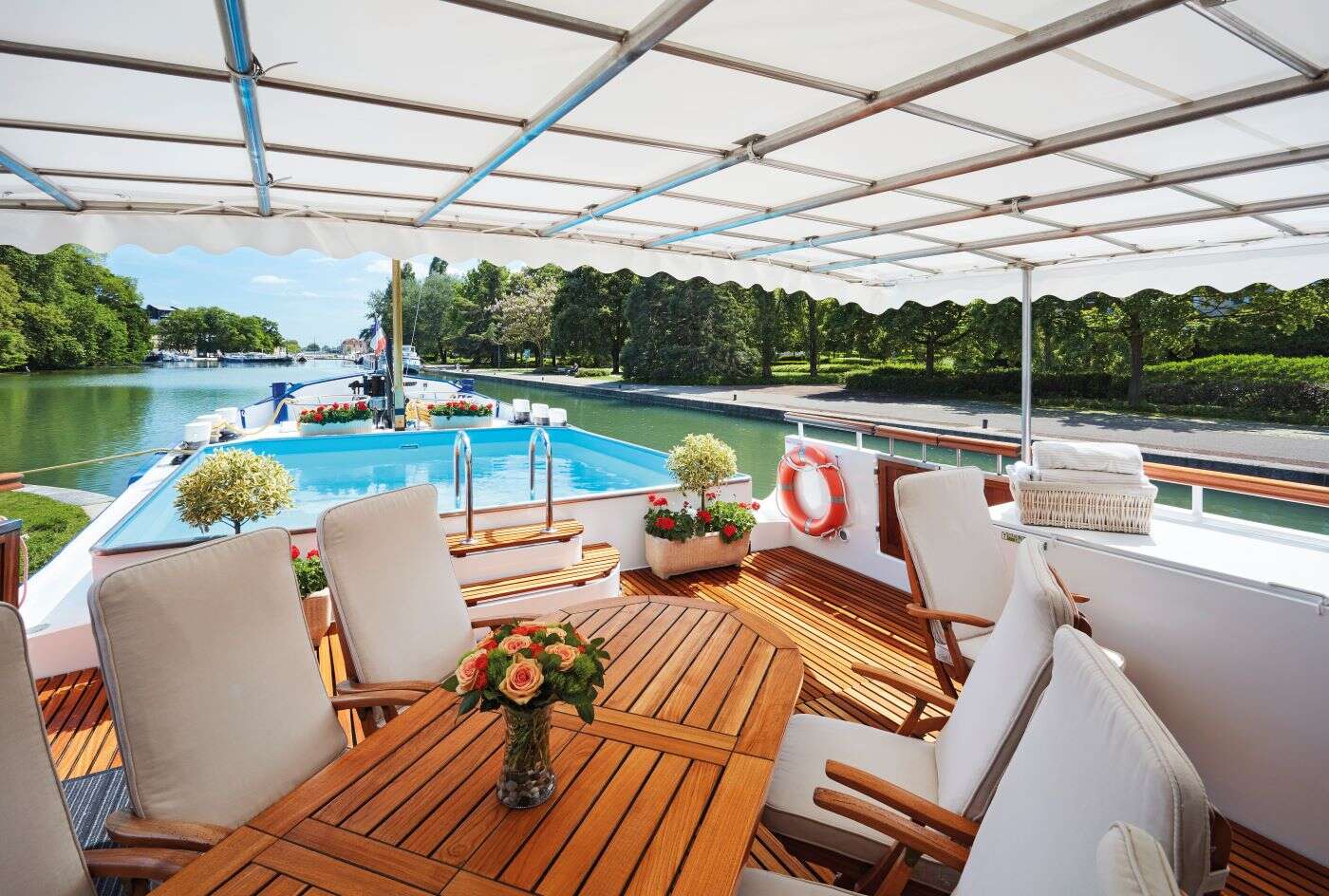 Deck of Belmond Barge featuring dining table and pool
