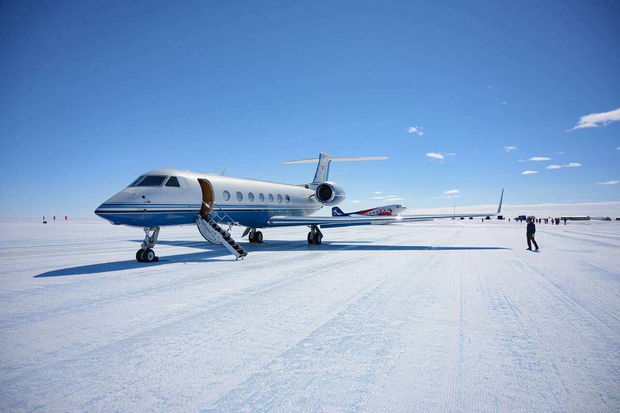 white desert private jet SAF fuel on snow runway