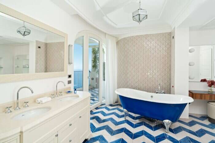 bathroom with floor to ceiling view of amalfi coast
