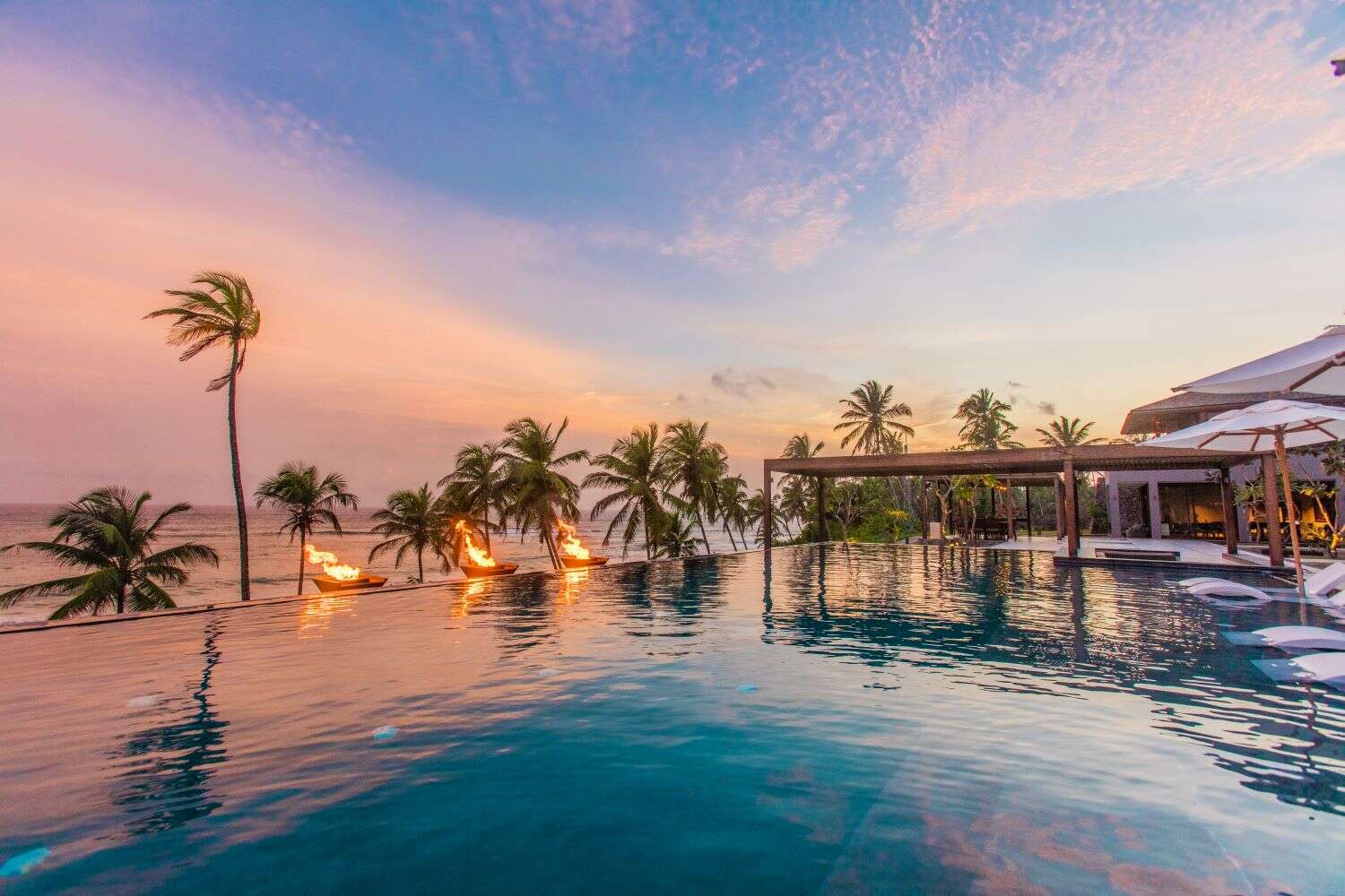 Sunset over pool at ÀNI Private Resort Sri Lanka