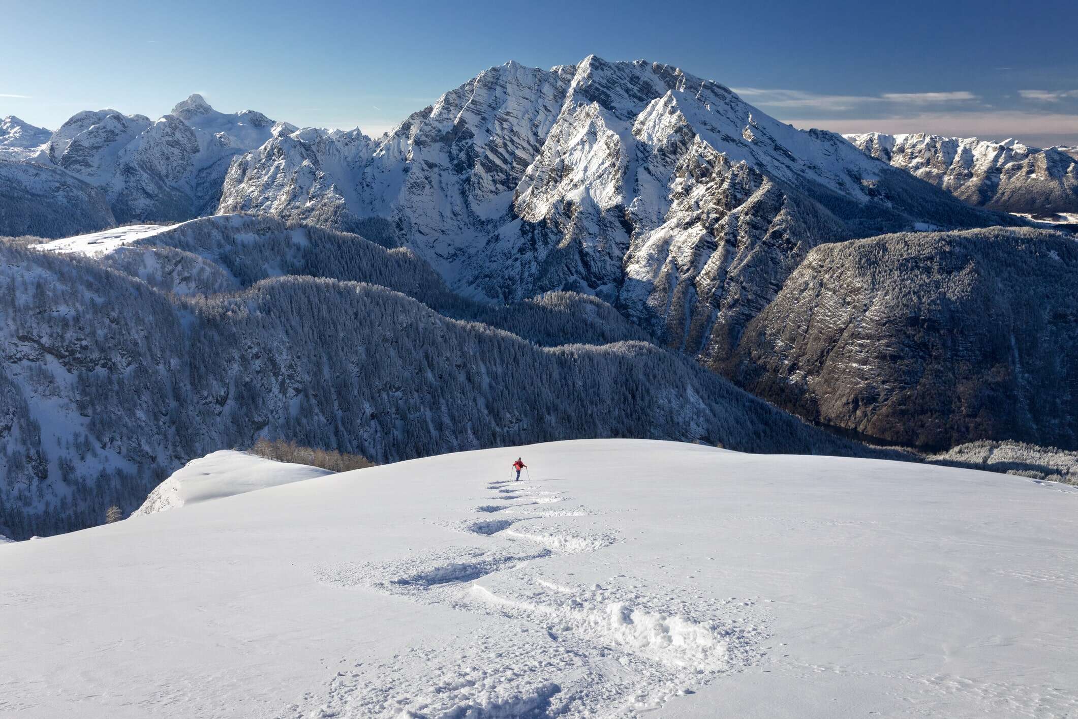 person skiing through mountains at alpine ski resort
