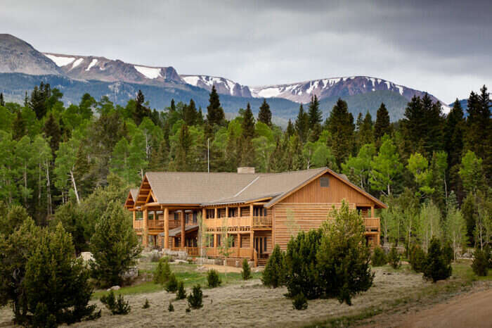 Costilla Lodge at Vermejo Ted Turner Reserve with mountains and trees