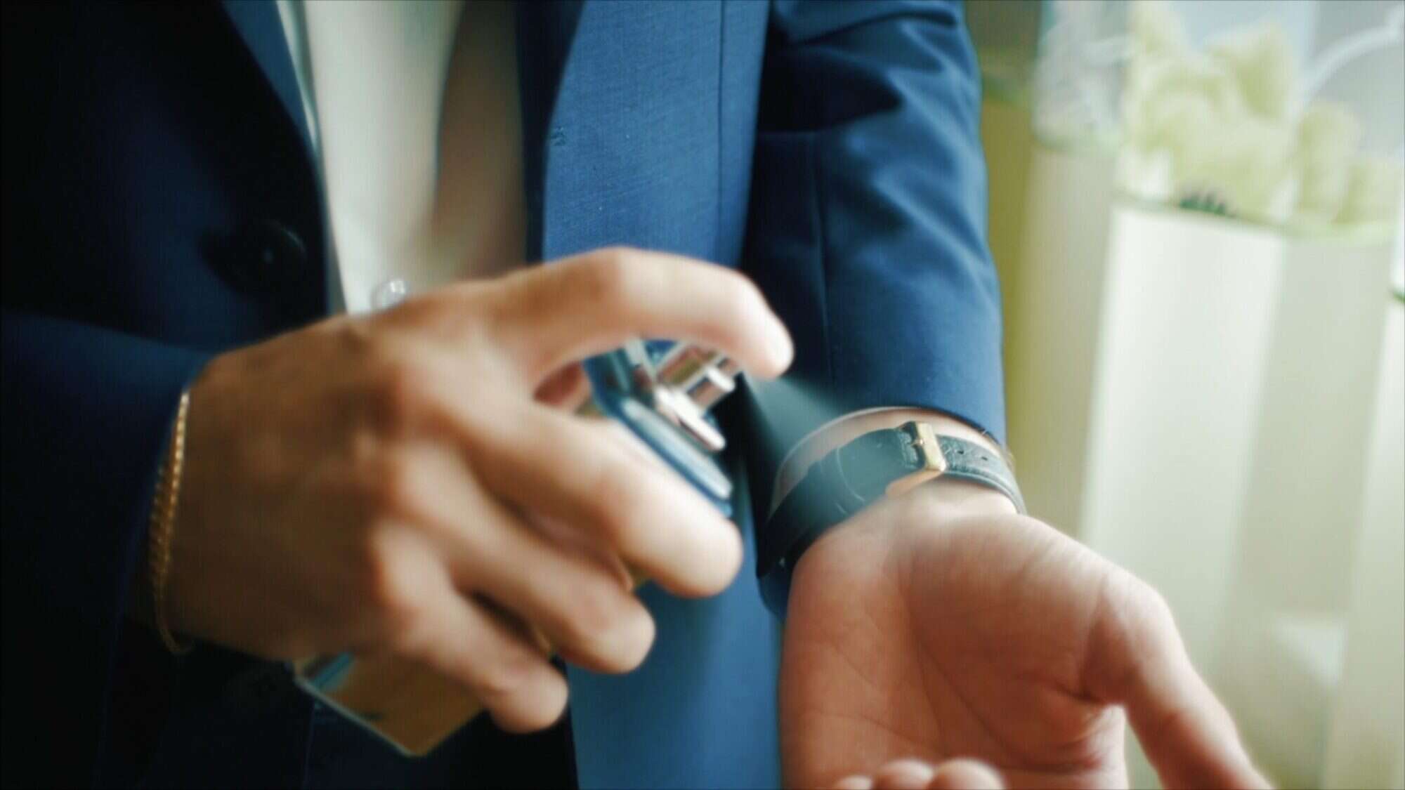 man spraying luxury perfume on wrist