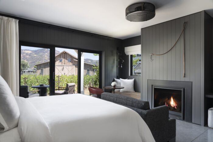 four seasons napa valley guestroom with fire and vineyard view
