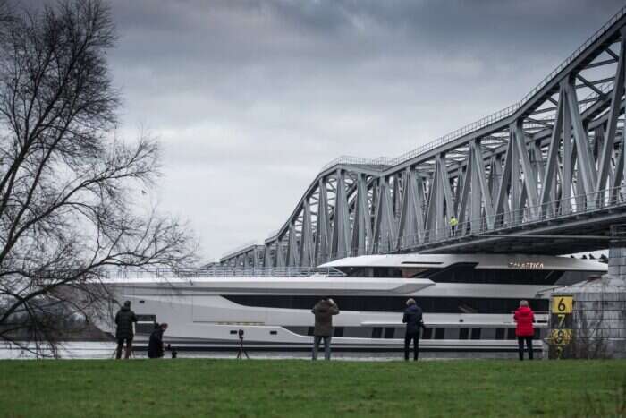galactica yacht goes under a bridge
