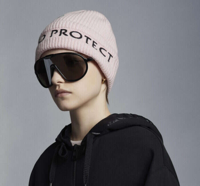 woman modelling pink moncler born to run hat