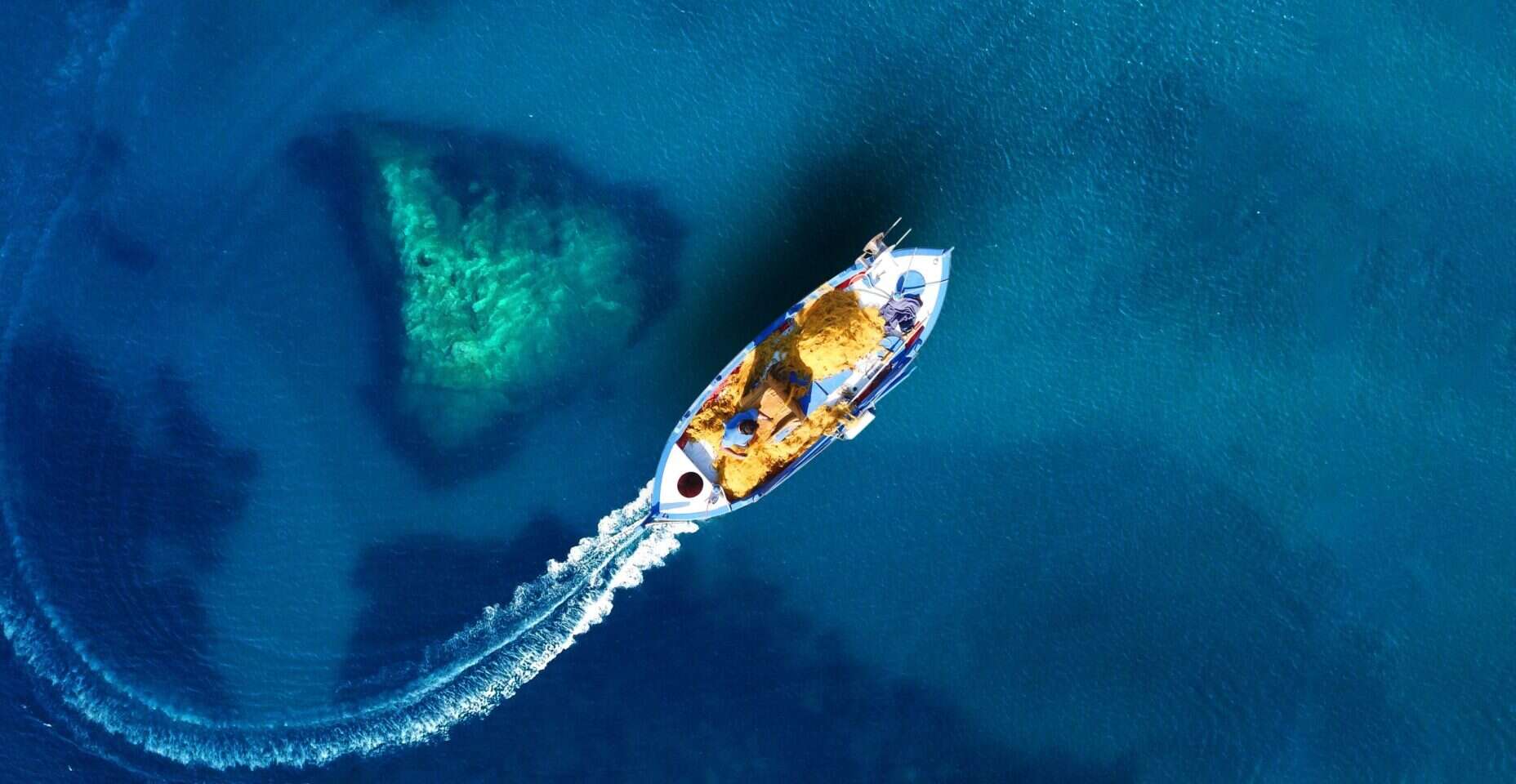 fishing boat in the middle of the ocean