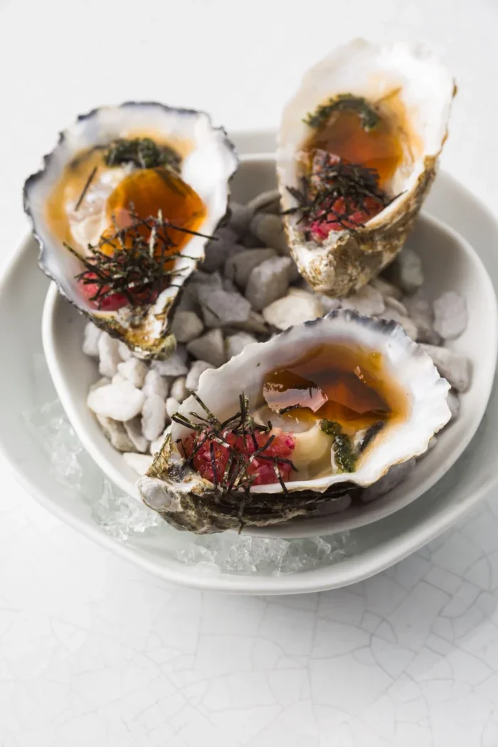 Oysters dotted with dashi, umemboshi, pickled chalaca and red algae