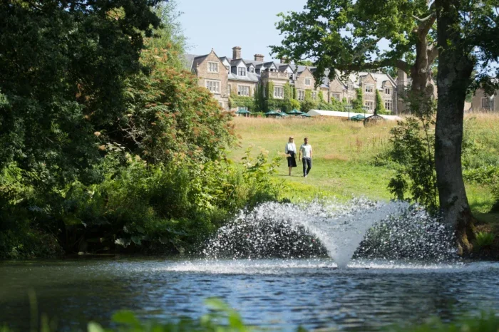 Man and woman walking in South Lodge grounds 