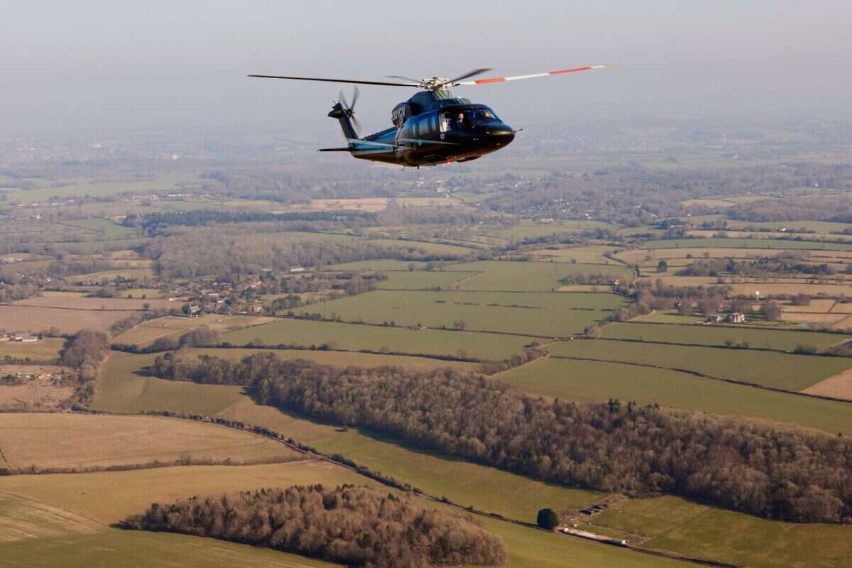 Flexjet Sivorsky helicopter flying UK countryside 