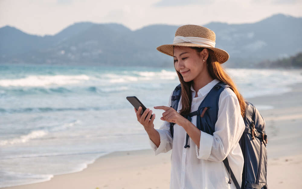 Woman on phone on beach
