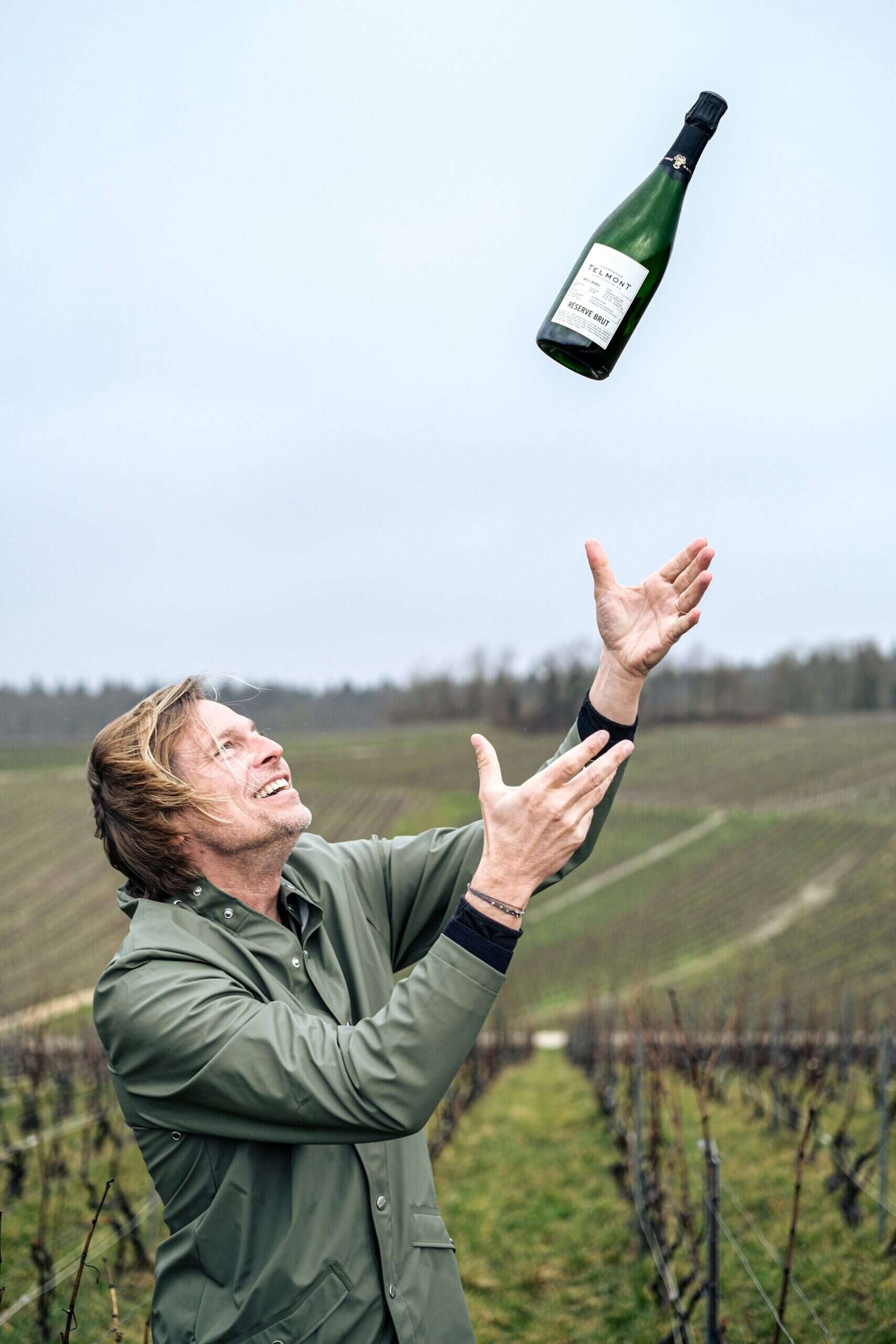 Ludovic du Plessis catches bottle of Telmont champagne 