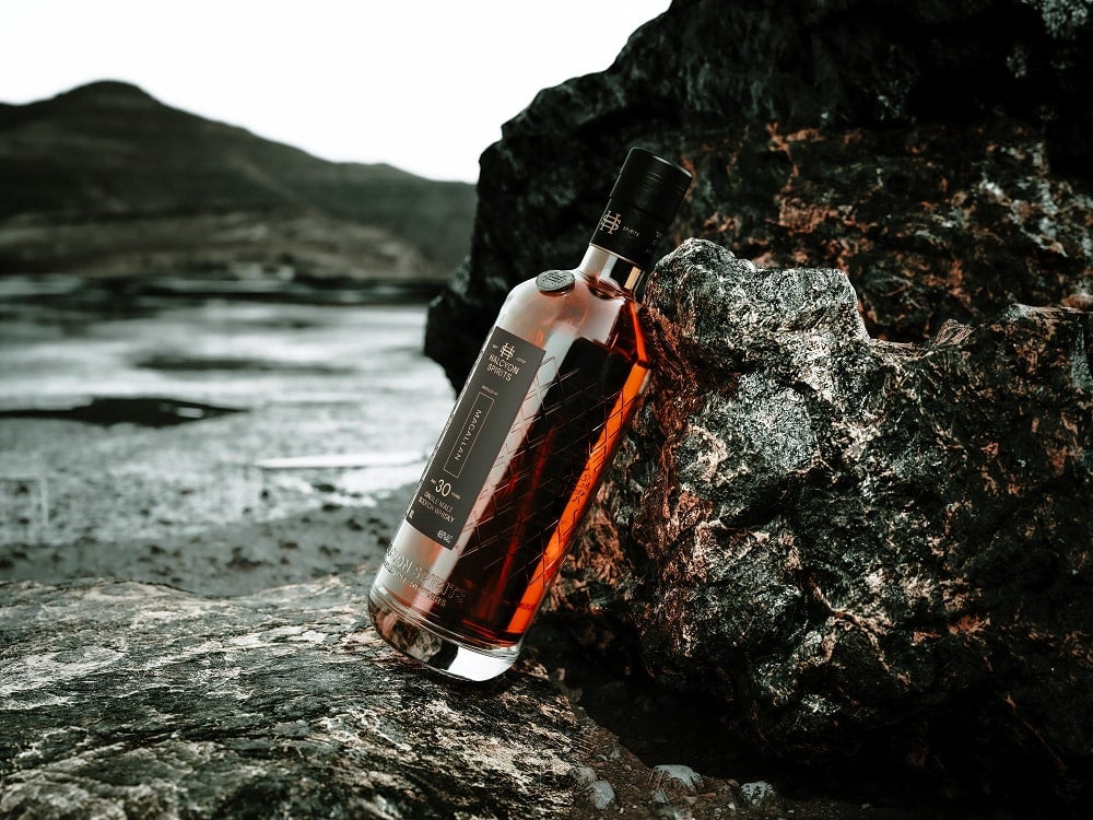 Halcyon Spirits bottle resting on a rock
