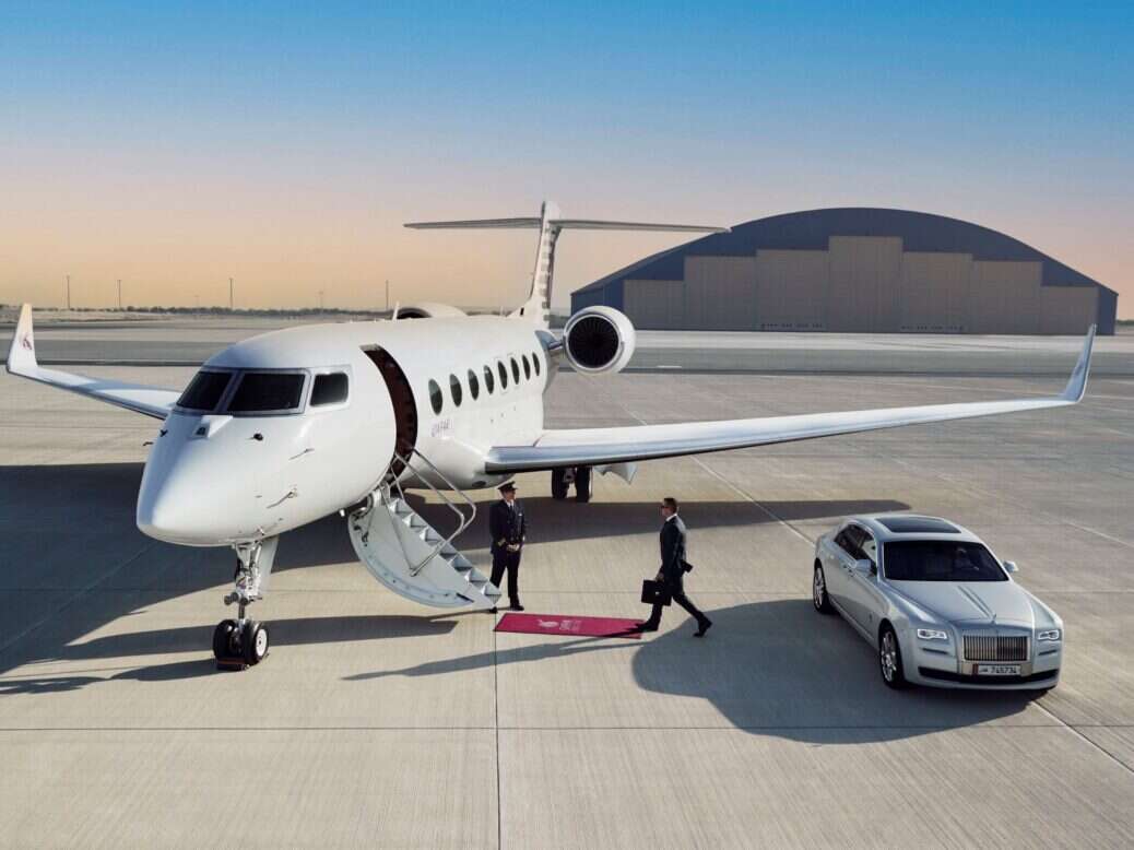car next to private jet