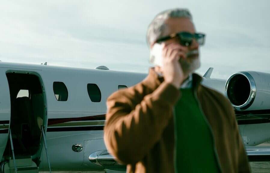 MAN ON PHONE near a jet