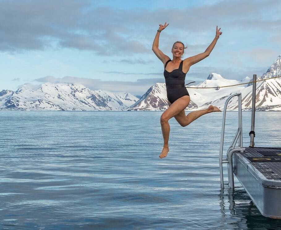 Cold plunge lady jumping in a lake