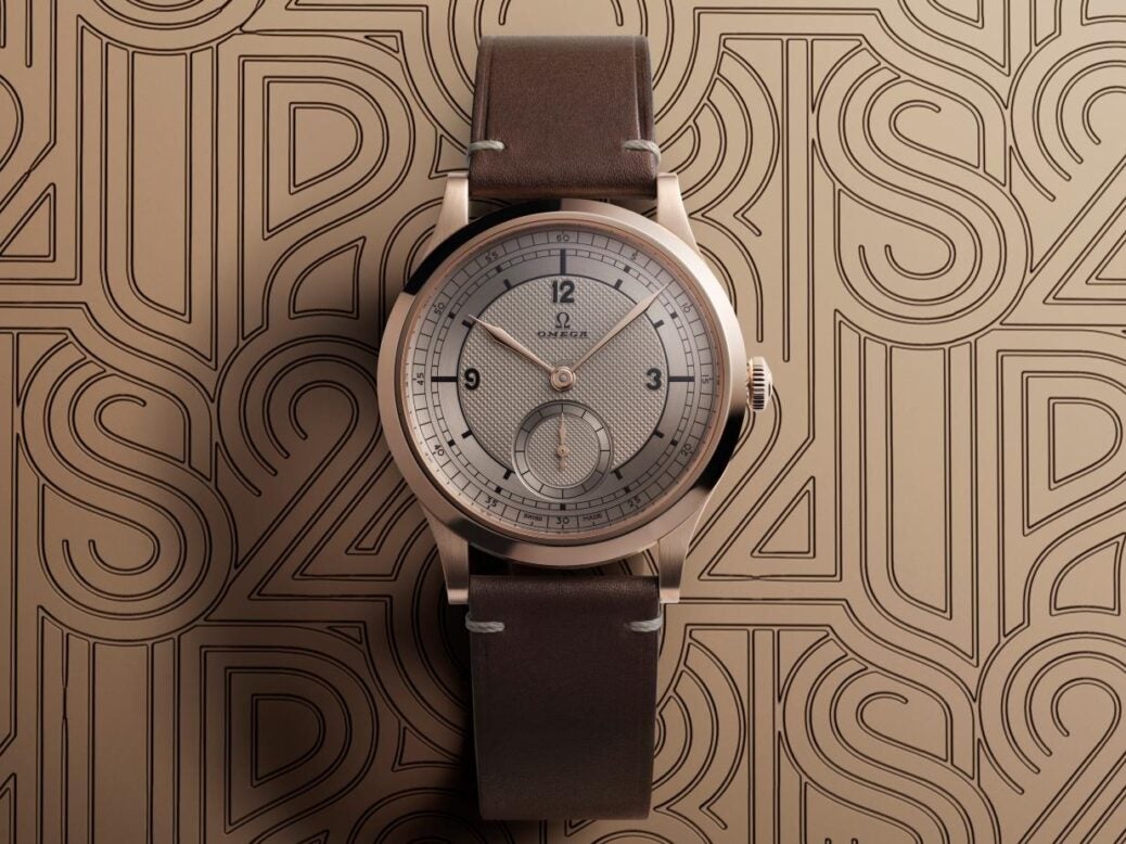 Image showing Omega Paris 2024 Bronze Gold Edition against a patterned bronze background.