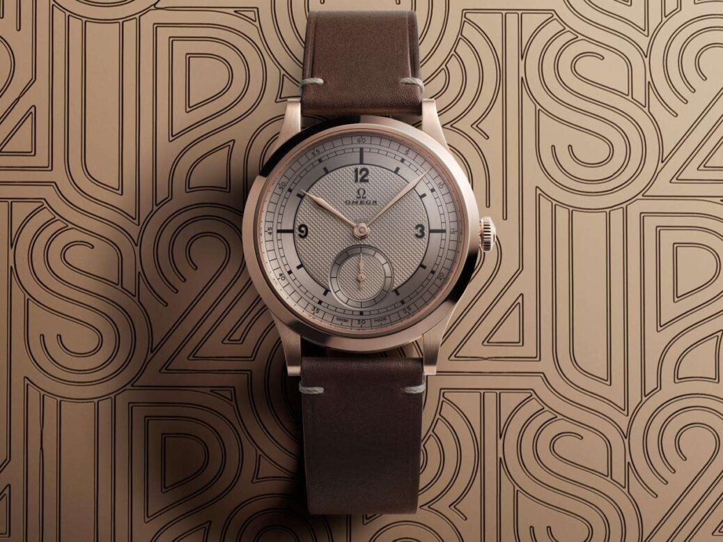 Image showing Omega Paris 2024 Bronze Gold Edition against a patterned bronze background.