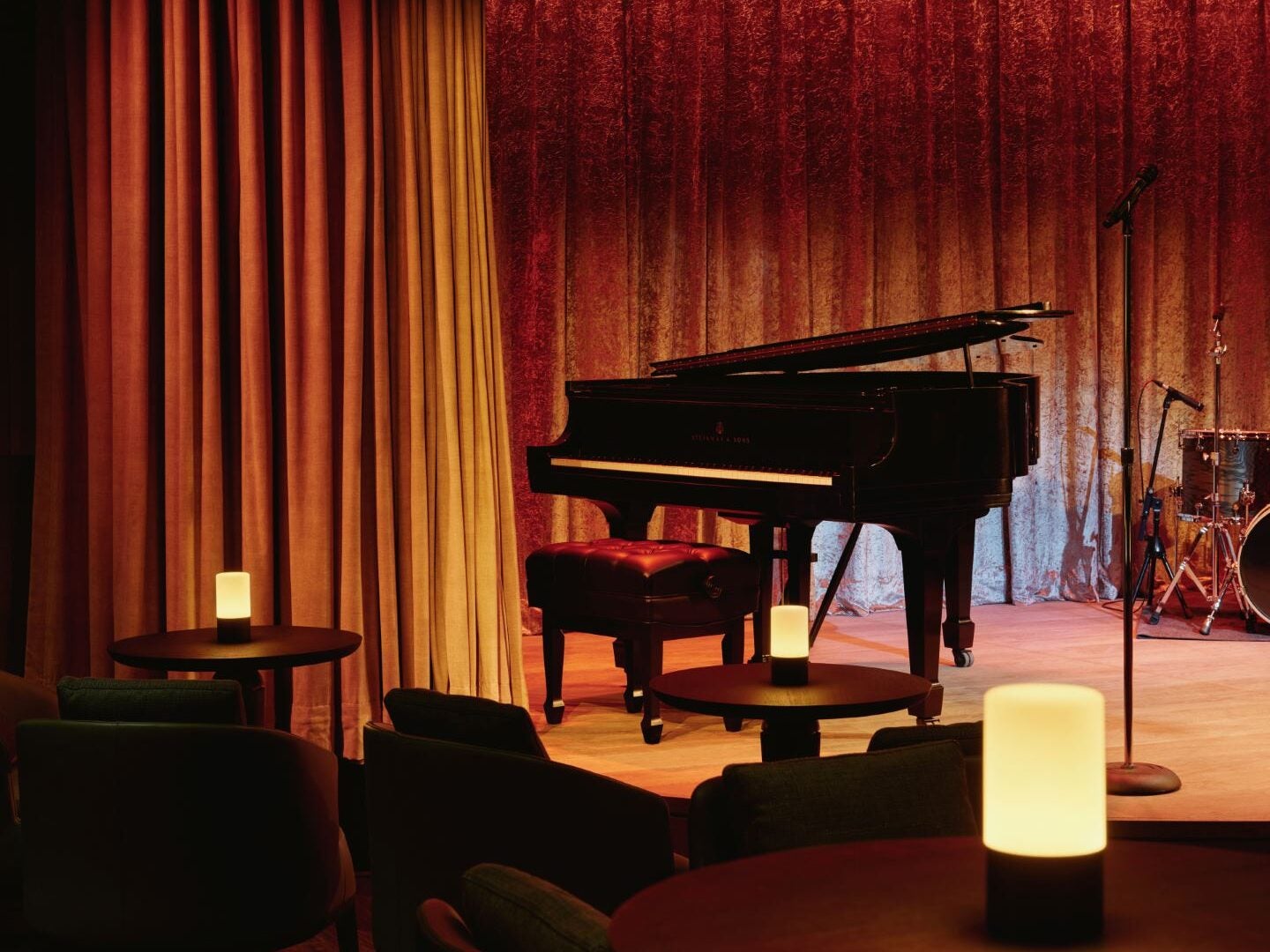 Image showing a piano in front of a red curtain at The Jazz Club for entertainment after the US Open