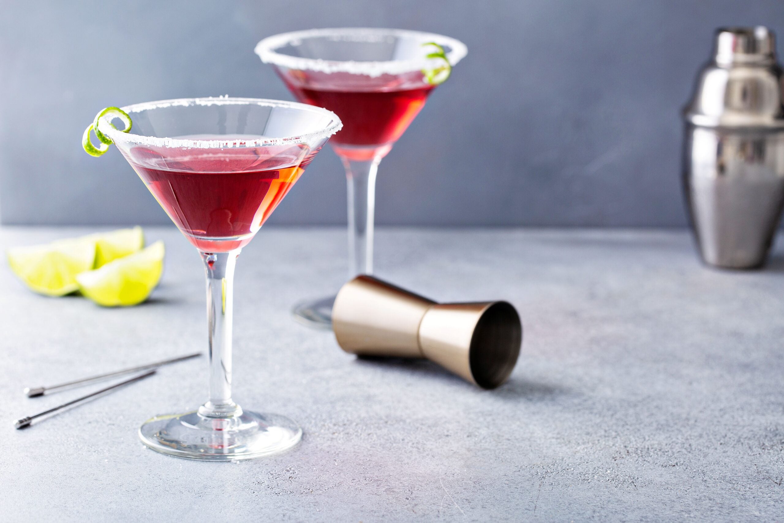 Two cosmopolitan cocktails with wine measurer