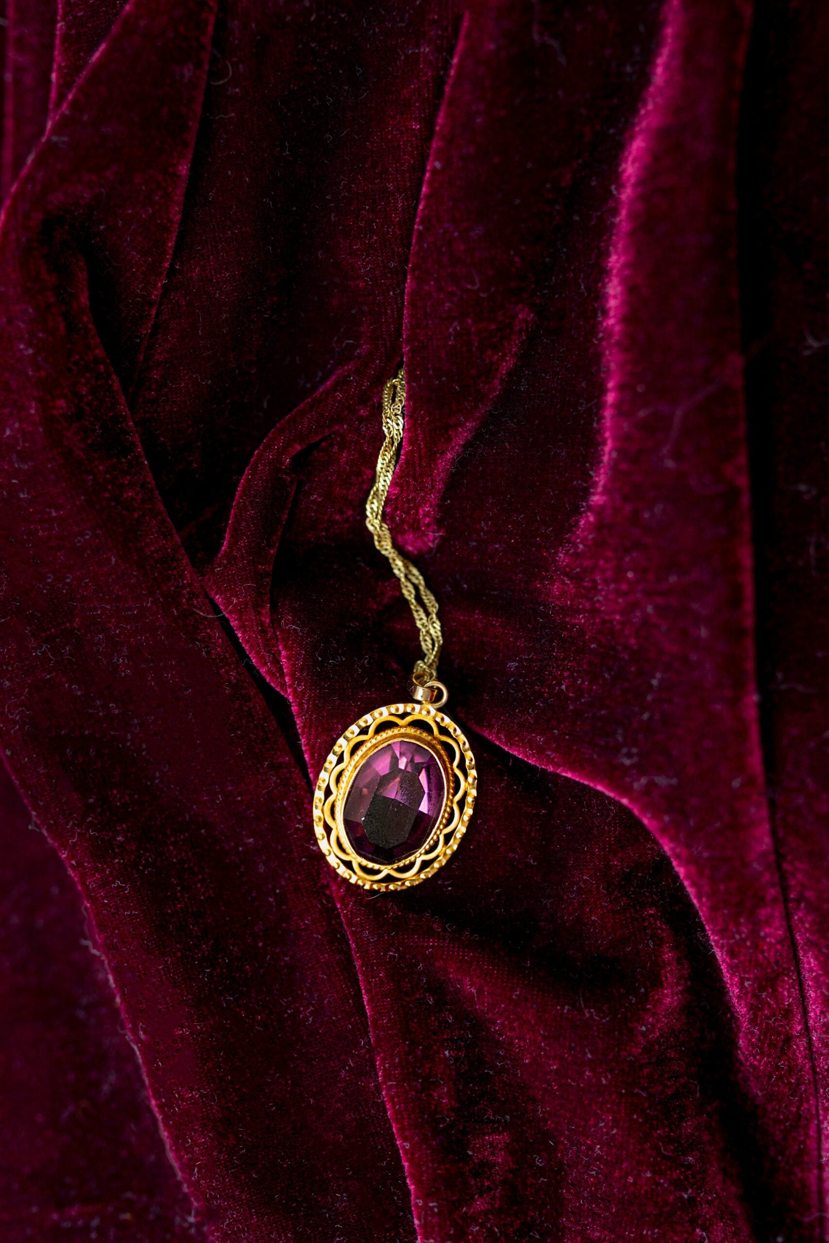 Artefact necklace on red velvet background ; should you wear ancient artefacts as jewelry debate